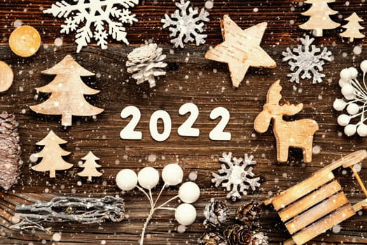 Letters Building The Word 2020. Wooden Christmas Decoration Like Tree, Sled And Star. Brown Wooden Background With Snowflakes