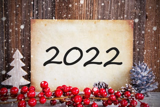 Paper With Text 2022 For Happy New Year Greetings. Christmas Decoration And Wooden Background With Snow
