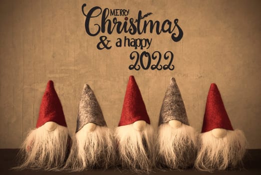 Five Santa With Hat. Concrete Background With English Calligraphy Merry Christmas And A Happy 2022
