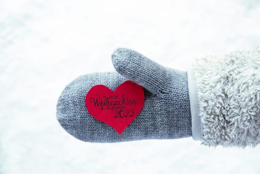 Red Heart With German Calligraphy Frohe Weihnachten Und Ein Glueckliches 2022 Means Merry Christmas And A Happy 2022. Hand In A Glove With Fleece And Snow.