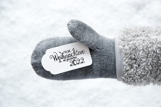 Label With German Calligraphy Frohe Weihnachten Und Ein Glueckliches 2022 Means Merry Christmas And A Happy 2022. Gray Glove With Snow Background