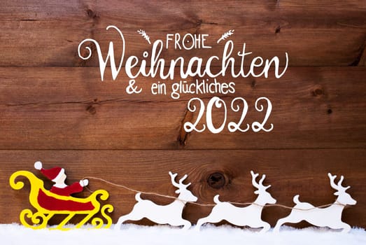German Calligraphy Frohe Weihnachent Und Ein Glueckliches 2022 Means Merry Christmas And Happy 2022. Santa Claus With Sleigh And Reindeers. Wooden Background With Snow