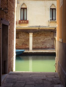 Narrow street with water dead end in Venice, Italy