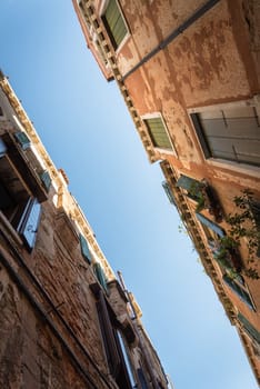 Photo of the sky between houses with a perspective to the top close up