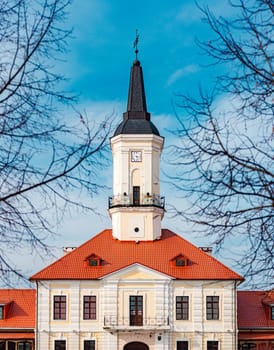 Historic architecture of Belarus. Old building with tower. Blue sky in background.