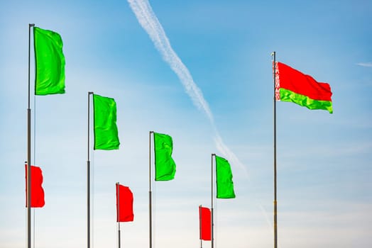 Flag of Belarus waving against blue sky without clouds