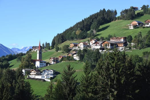 The mountain village of St. Leonhard near Brixen in the Province of Bozen in South Tyrol,Italy. St. Leonhard's Church is in the center of town. It was inaugurated in 1194,redesigned around 1430 and later baroque-styled.