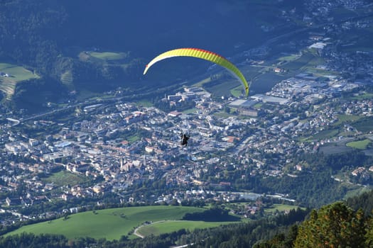 A paraglider over Brixen in South Tyrol - Trentino,Italy. The city is located on the Eisack River in the Eisack Valley about 40 km north of Bozen.