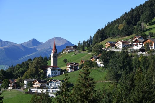 The mountain village of St. Leonhard near Brixen in the province of Bozen in South Tyrol,Italy. St. Leonhard's Church is in the center of the village. It was inaugurated in 1194,redesigned around 1430 and later redesigned in Baroque style.