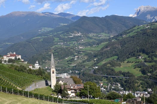 Panoramic view over the Eisack valley with the church of St. Valentino,Säben monastery,Church of Our Lady,Klausen,the Brenner motorway,the towns of Gufidaun and Teis in the background the Peitlerkofel and Plose mountains
