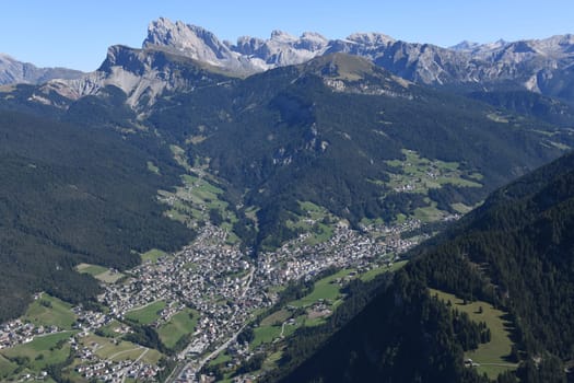 Aerial view of the town of Sankt Ortisei Val Gardena in Val Gardena. The official languages are German,Italian and Ladin. In the background the mountain massif of the Geislerspitzen.