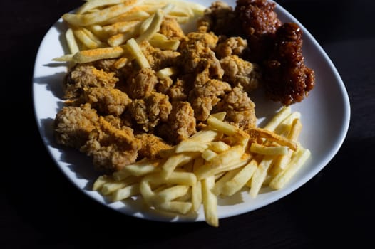 fried chicken with french fries and nuggets meal . Concept junk food