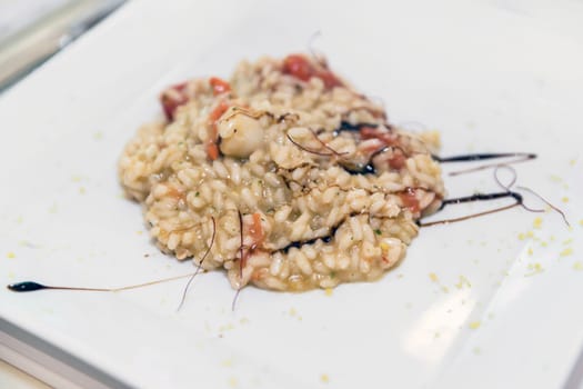 Seafood italian rice. Seafood rice or risotto with seafood and decorated with icing vinegar. Italian food.