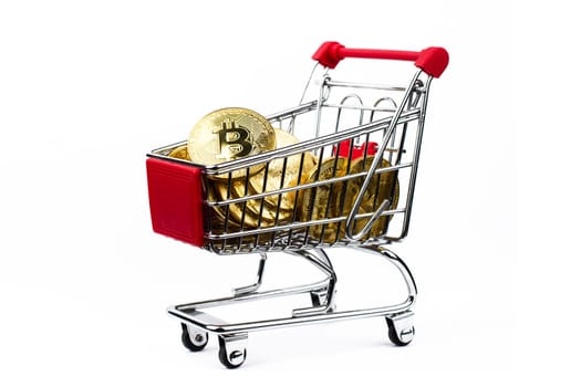 side view closeup cryptocurrency concept of market shopping cart full of bitcoin golden crypto coins isolated on white background