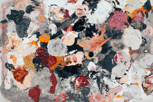 top view closeup of artist color mixing palette with colored brush strokes