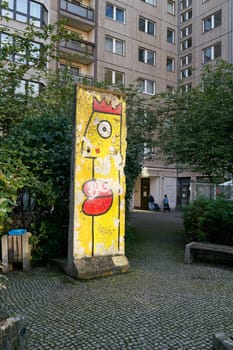 Original part of the Berlin Wall as decoration on a backyard in Berlin