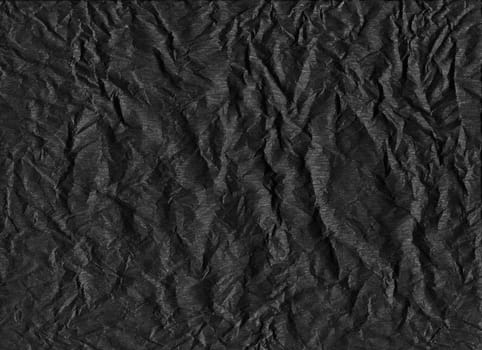 horizontal front view of crumpled dark black paper texture with heavy wrinkles background