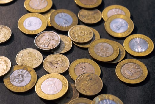 Heap of Gold Colored Indian Rupee Coin currency on rustic floor. Full Frame. High Angle View. Business Finance and financial Investment Background. Close Up