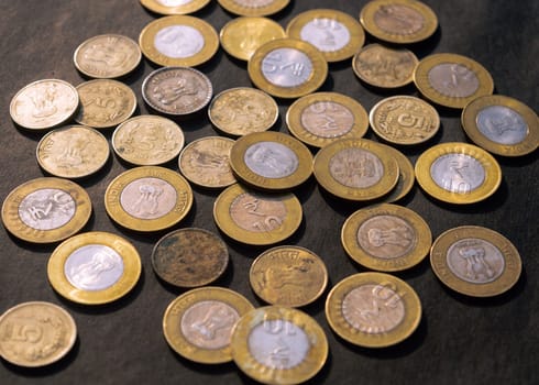 Heap of Gold Colored Indian Rupee Coin currency on rustic floor. Full Frame. High Angle View. Business Finance and financial Investment Background. Close Up