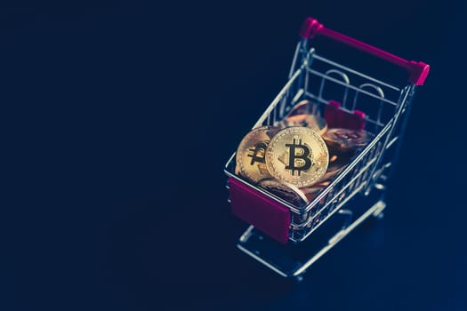 side view closeup cryptocurrency concept of market shopping cart full of bitcoin golden crypto coins on dark black background