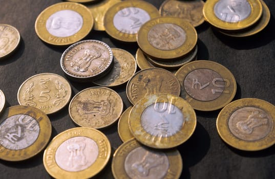 Heap of Gold Colored Indian Rupee Coin currency on rustic floor. Full Frame. High Angle View. Business Finance and financial Investment Background. Close Up