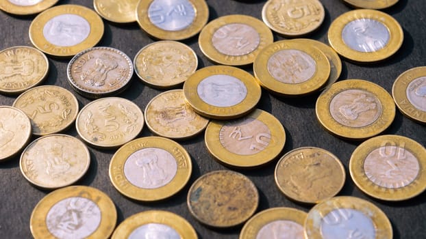 Heap of Gold Colored Indian Rupee Coin currency on rustic floor. Full Frame. High Angle View. Business Finance and financial Investment Background. Close Up