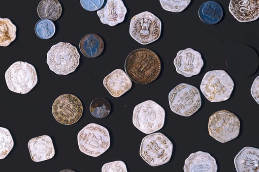 Mix of old antique obsolete Indian Rupee Coin currency on rustic floor. Full Frame. Table Top View. Close Up