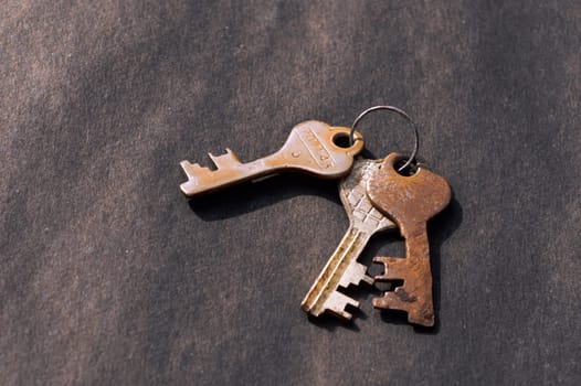 Bunch of old House Key isolated on a rustic Floor. High Angle View. Copy space room for text. Safety secure protection background concept.