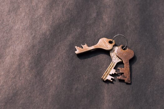 Bunch of old House Key isolated on a rustic Floor. High Angle View. Copy space room for text. Safety secure protection background concept.