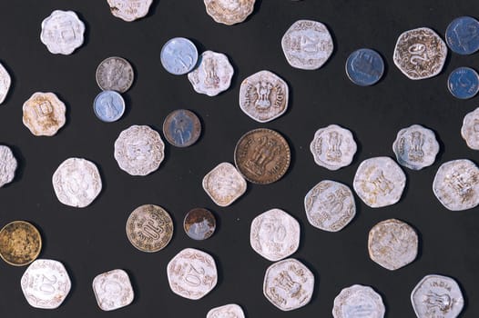Mix of old antique obsolete Indian Rupee Coin currency on rustic floor. Full Frame. Table Top View. Close Up
