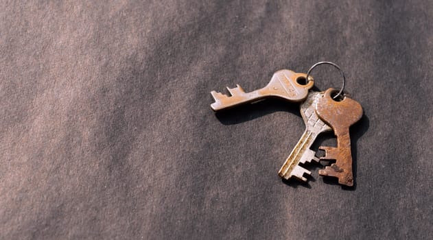 Bunch of old House Key isolated on a rustic Floor. High Angle View. Copy space room for text. Safety secure protection background concept.