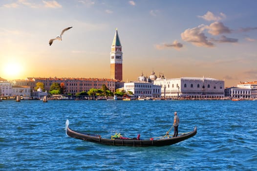 Gondola in the lagoon and the main view of Venice, Italy.