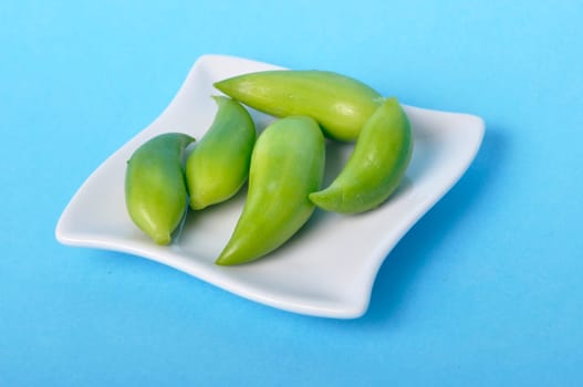 Achocha in a saucer on a blue background
