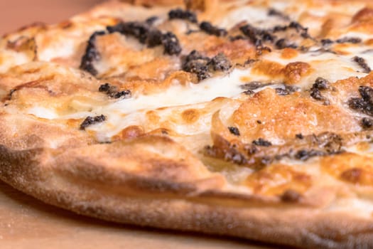 Simple pizza with crunchy crust. Italian pizza. Closeup.