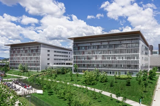 ASST Ospedale Papa Giovanni XXIII. Bergamo, ITALY - May 9, 2017.  Modern hospital with blue sky, surrounded by trees.