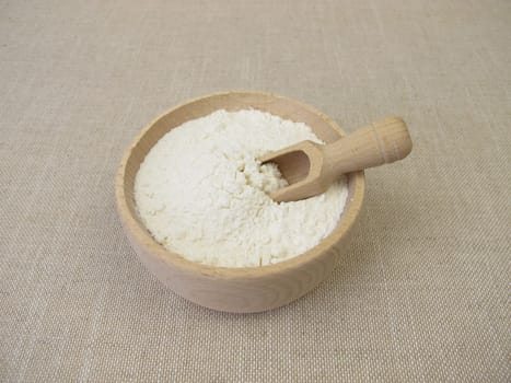 Fine wheat flour in a wooden bowl for the production of baked goods and pasta