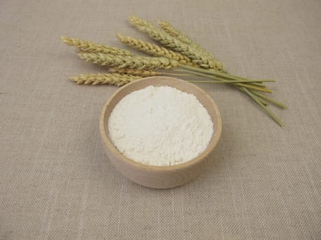 Fine wheat flour in a wooden bowl for the production of baked goods and pasta