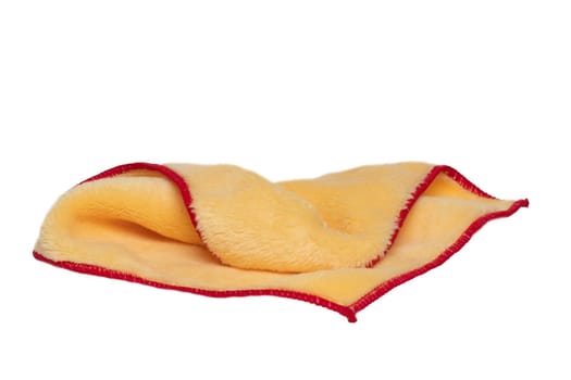 Household cleanliness and hygiene. Close-up of a yellow cleaning cloth isolated on a white background. Microfiber cleaning cloth. Macro.