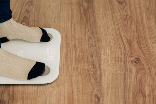 Modern Electronic Device. Girl Measures Weight on Smart Scales.