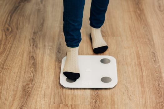 Modern Electronic Device. Girl Measures Weight on Smart Scales.