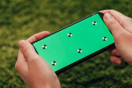 Girl Holds An New Smart Phone In Her Hand. Chroma Key Green.