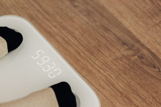 Modern Electronic Device. Girl Measures Weight on Smart Scales.