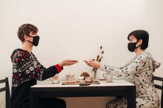 Girl and Guy Drinking Tea at Home in Masks.