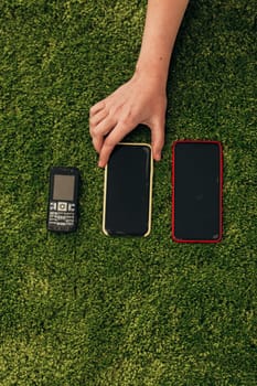 The Human Hand Choosing Phone That Lies Near New Smartphones.