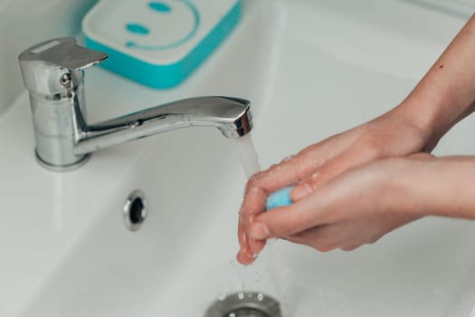 The Girl Washes Her Hands to Avoid Infection With the Virus COVID-19.
