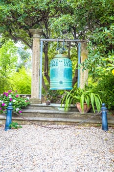VENTIMIGLIA, ITALY - CIRCA AUGUST 2020: old Japanese bell located in Hambury Gardens and finely crafted in bronze. It seems to come from a Buddhist shrine destroyed by a fire in central Japan.
