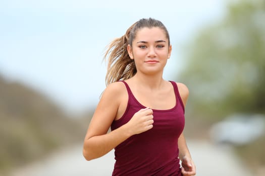 Teenage runner running in the mountain