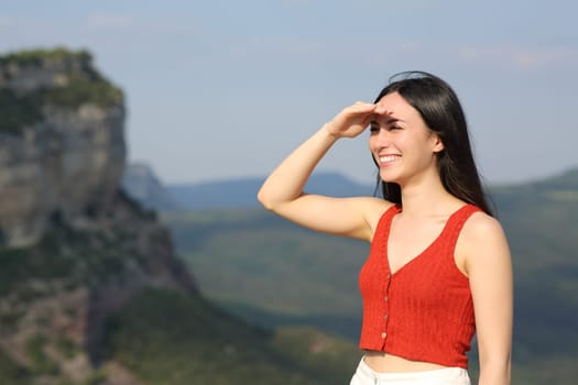 Happy asian woman seaching protecting from sun outdoors