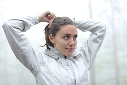 Trekker doing ponytail in a forest
