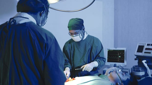 Medical surgical doctor team performing surgery patient, Group surgeon at work on operating room with electrocautery equipment for cardiovascular emergency surgery center in hospital